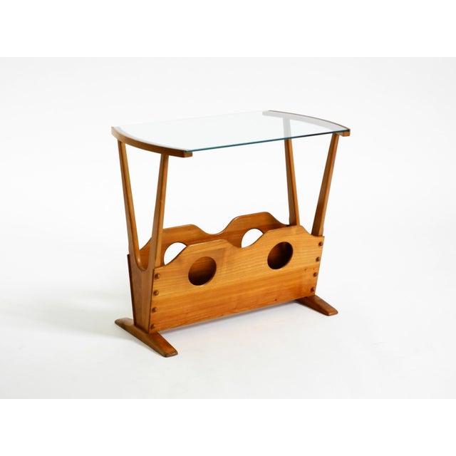 Very rare, beautiful mid-century modern side table with one magazine rack, made of ash wood and featuring a glass shelf. A...