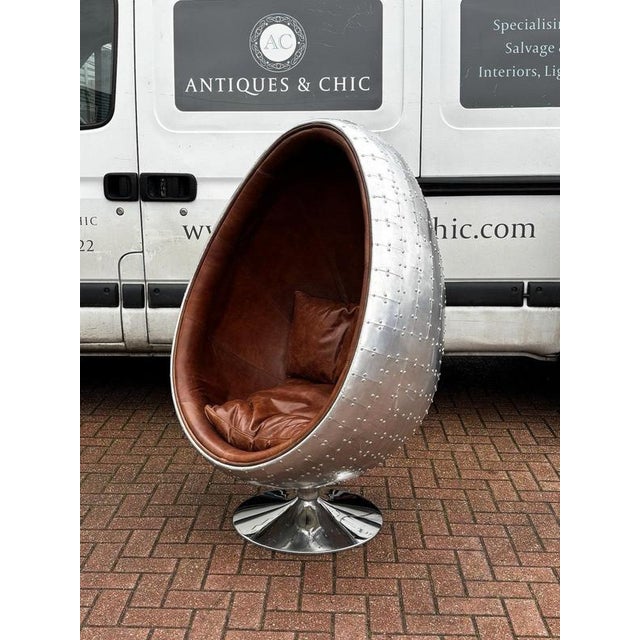 Aviation Swivel Egg Chair with Tan Leather. Sizes 145 cms tall, 99 cms A used item so will have signs of use, See pics
