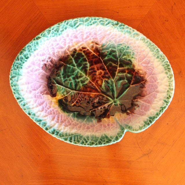 An antique begonia leaf serving dish, suitable for use or display. The colors are vivid: emerald and amethyst, along with...