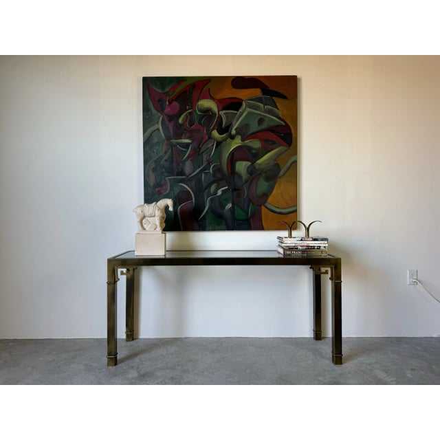 Mastercraft Greek Key Brass and Glass Console Table This striking Hollywood Regency console table by Mastercraft features...