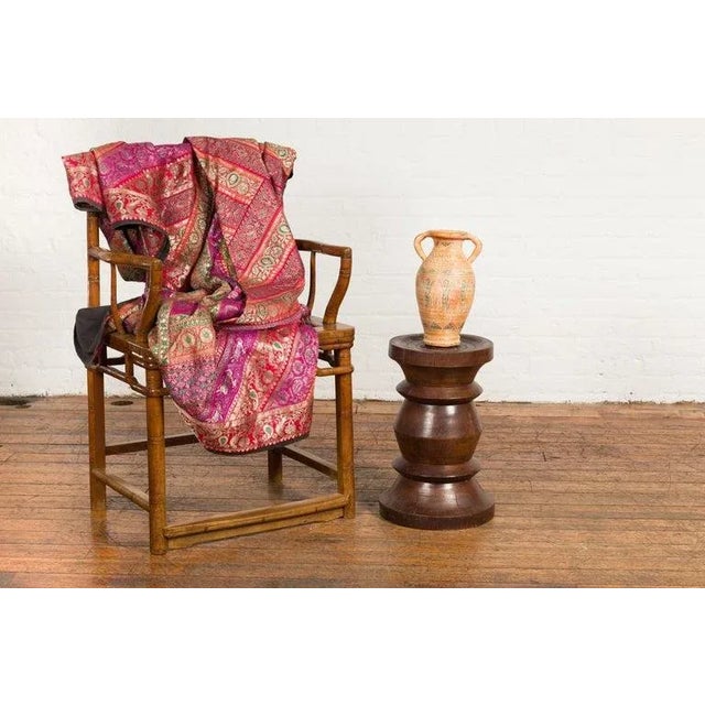An Indonesian turned wooden stool from the 19th century with brown patina. Crafted in Indonesia during the 19th century,...