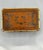This early 20th-century Chinese wooden box, measuring 6 3/4" L x 4 1/4" W x 2 1/2" H, is elegantly covered in decorated...
