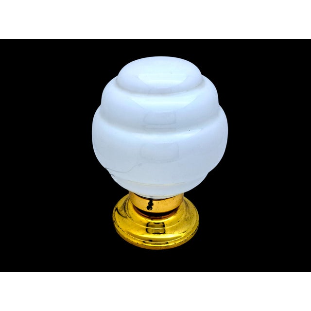 This lamp, with a gold base and opaline white Murano glass, will add a touch of elegance to any space. Its MCM-style...