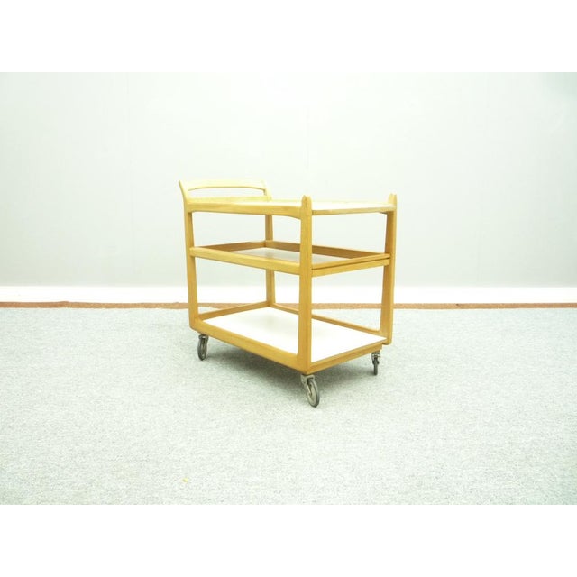 Very rare bar trolley from the 1950s. Anthroposophical design by Felix Kayser. The bar trolley has a removable tray. The...