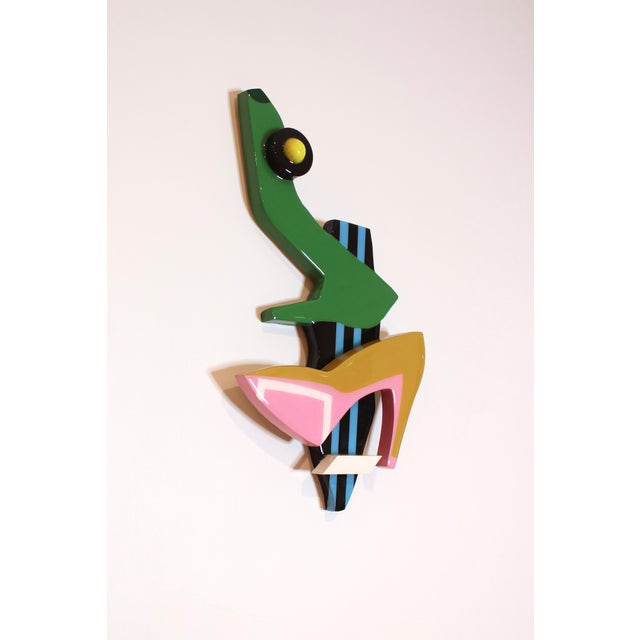 Shiny, resin coated wooden sculptural piece for hanging. Featuring a fashionable subject matter and great physical...