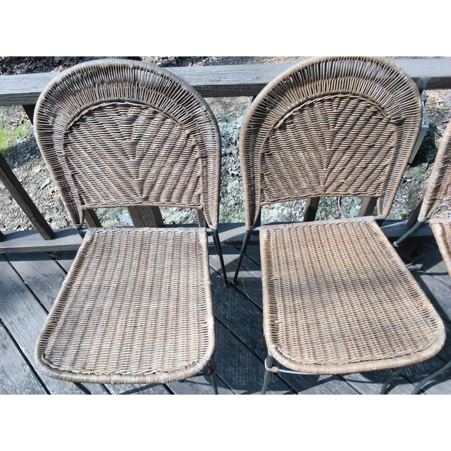 These 5 vintage wicker and wrought iron stackable chairs likely were designed by Frederick Weinberg or Herta Maria...