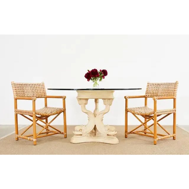 Amazing round pedestal center table or dining table featuring a neoclassical Venetian or grotto style triple dolphin motif...