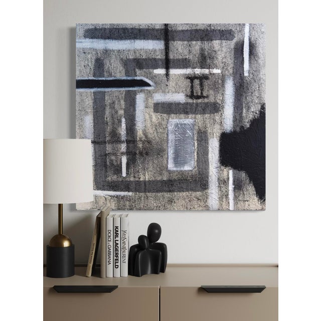 In Polarization, J. Kent Martin constructs a refined arrangement of tonal blocks—charcoal, slate, warm gray, and muted...
