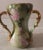 This marvelous antique Art Nouveau three handled hour-glass shaped chalice is created in gorgeous white porcelain and is...