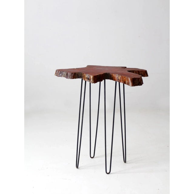 Striking mid-century accent table featuring a sculptural live-edge burl top with an intriguingly abstract, ink-blot-like...