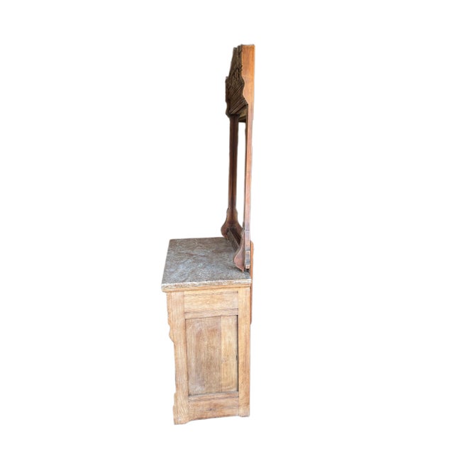 A beautifully crafted antique European dresser in solid walnut wood with an original rose-toned marble top and attached...