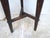 This rustic end table has a crossbar and dished top.