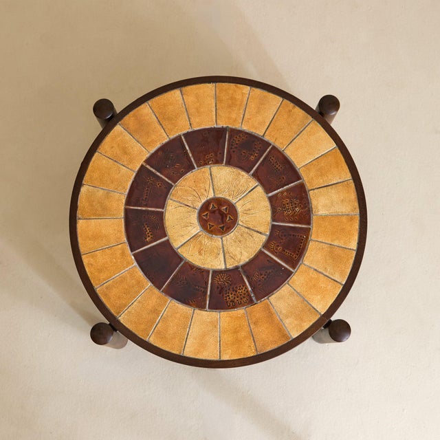 A French coffee table from the 1960s, attributed to Roger Capron, where symbolism and structure are held in careful...