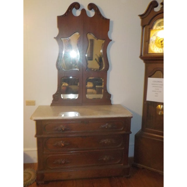 An American Victorian Walnut Marble Top Dresser Together With a
