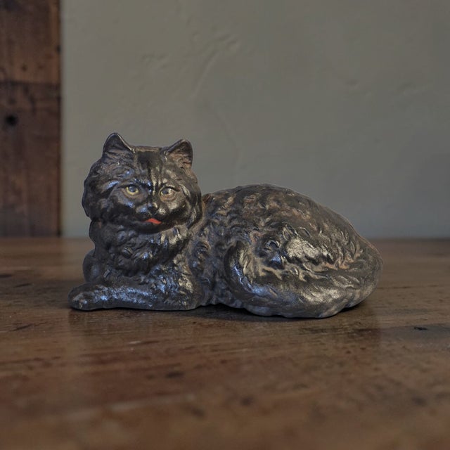 The Antique Cast Iron Black Cat Doorstop is a unique and charming collectible piece that adds character to any home decor....
