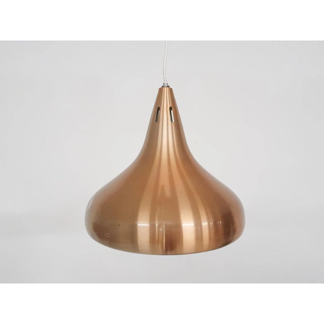 Copper colored pendant light. The lamp has some dents and traces of use. In the style of Fog and Morup Up to 250V...