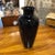 Wonderful hand blown glass vase in ebony with clear handles. Variations in size, shape and color may occur.