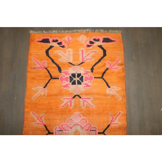 A mi 20th century Bright Orange Color Tibetan rug with a floral design