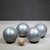 ABOUT A French mid-century set features four heavy metal pétanque boules and one wooden target ball crafted by the iconic...