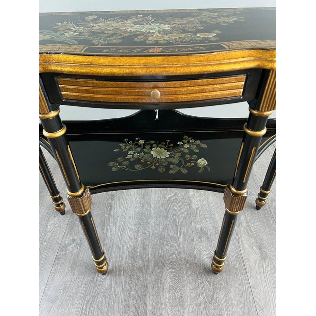 Painted and Gilded Half-Moon Console Table, Louis XVI Style An elegant half-moon console table in black lacquered wood,...