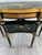 Painted and Gilded Half-Moon Console Table, Louis XVI Style An elegant half-moon console table in black lacquered wood,...