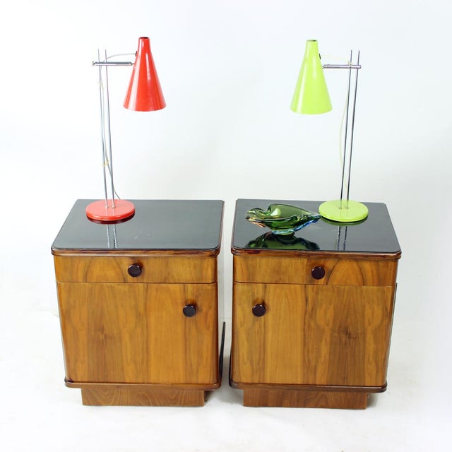 This beautiful pair of bedside tables was produced in Czechoslovakia in the 1950s and showcases classic mid-century...