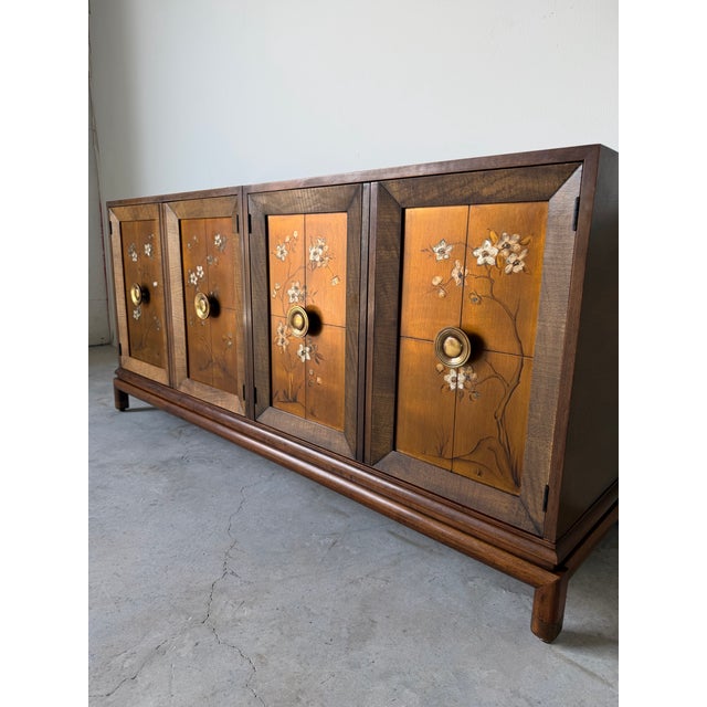 Elegant vintage sideboard in the style of Renzo Rutili, crafted in richly figured walnut with beautifully framed cabinet...