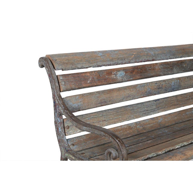 This Vintage Anglo-Indian Painted Teakwood and Cast-Iron Garden Bench is constructed with solid teakwood slats and...