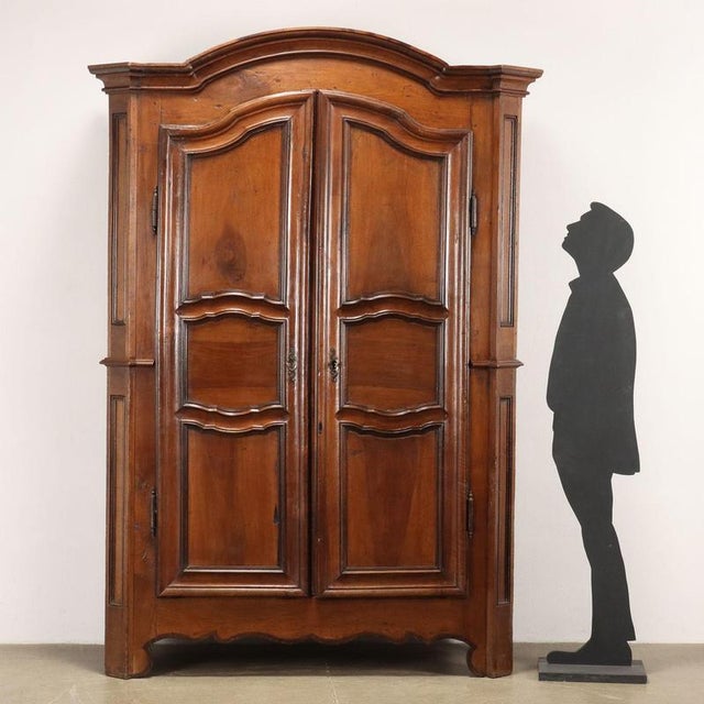 Wardrobe equipped with two paneled doors, in walnut. This piece is attributed to the mentioned designer/maker. It has no...