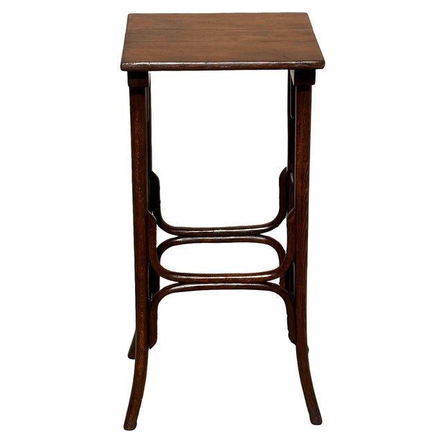 Turn of the century Thonet tall side table and plant stand features an elegant, sculptural frame crafted from warm-toned...