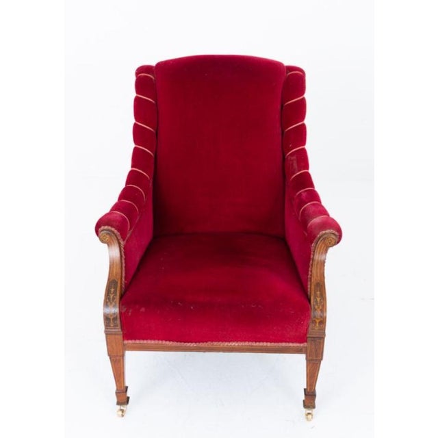A handsome Sheraton Revival club chair, raised upon elegant tapered legs terminating in brass castors Circa 1900 The...
