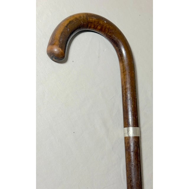 This antique sterling silver and malacca wood walking cane is a unique piece that exudes craftsmanship and elegance. The...