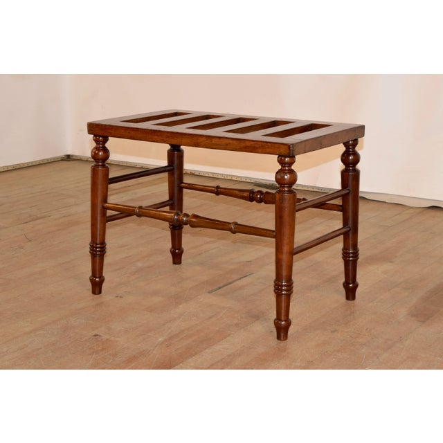 19th century mahogany luggage stand from England with a slatted top over hand turned and spayed legs, joined by lovely...