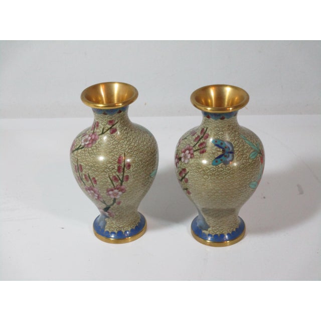 A wonderful pair of vintage Chinese cloisonne vases. They are made of brass with a decorative overlay enamel design of...