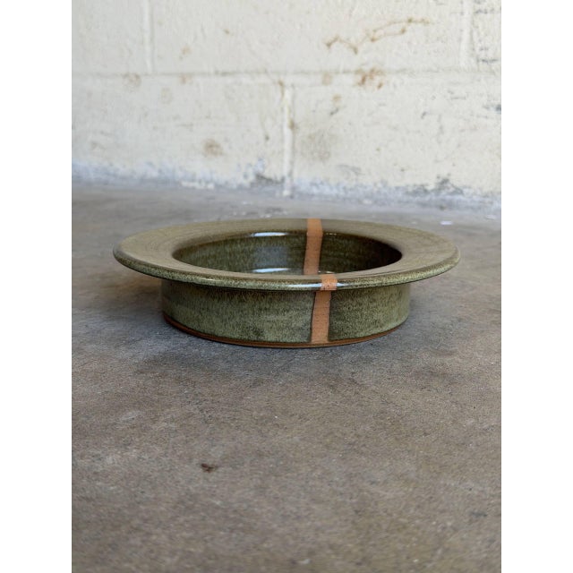 Vintage 1960s Danish Mid-Century Modern studio ceramic plate features a striking, minimalist design from the workshop of...