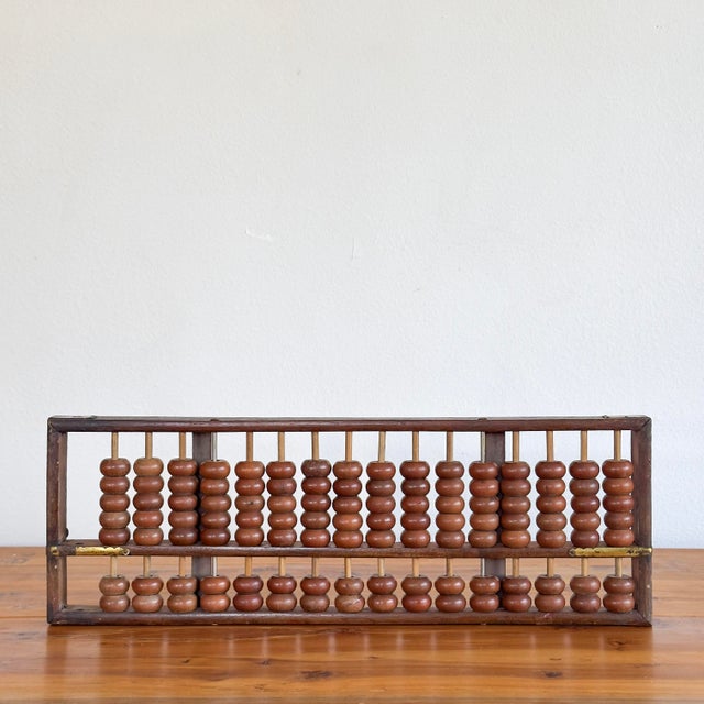 Vintage Chinese abacus with mahogany beads and brass hardware.