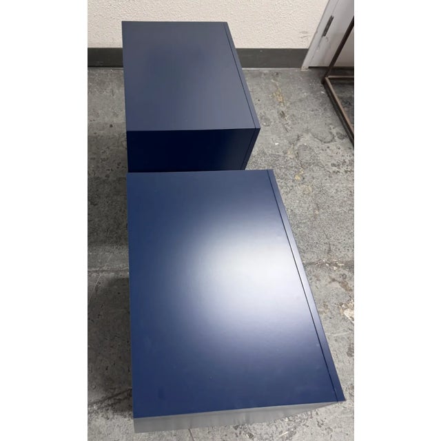 Design Plus Gallery presents a Pair of Audrey Navy Nightstands from Brownstone Furniture. These stylish bedside...