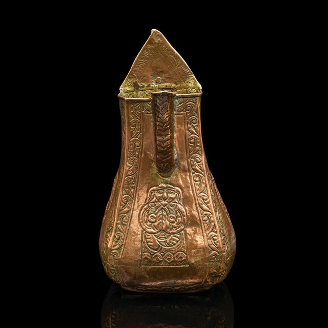 This is an antique serving jug. A Chinese, copper decorative ewer in provincial taste, dating to the early Victorian...