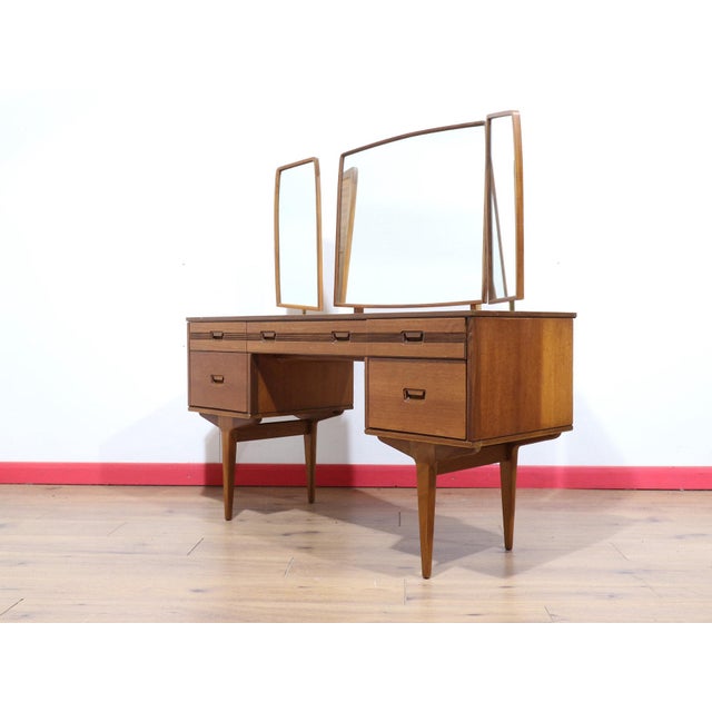 A stunning vanity made by British furniture maker Butilux, this Mid Century Modern Vintage Teak Vanity Desk embodies...