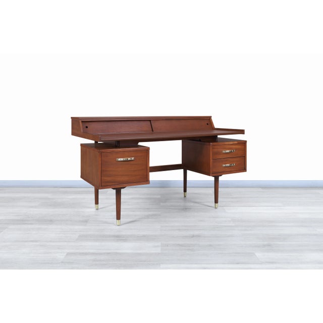 Wonderful vintage “Biscayne” floating top walnut desk by Drexel and manufactured in the United States, circa 1960s. This...