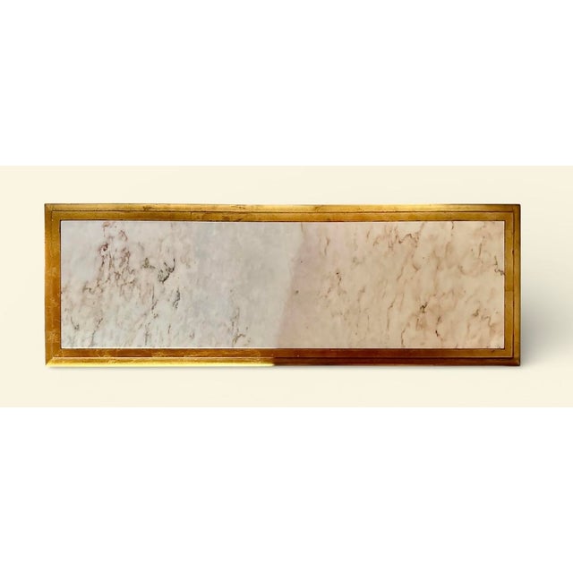 This beautiful, long rectangular coffee table with carved and giltwood open sided sled base is in the neoclassical or...