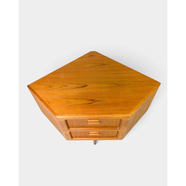 Original Danish corner chest of drawers manufactured by Dyrlund, crafted in teak and designed specifically to make elegant...