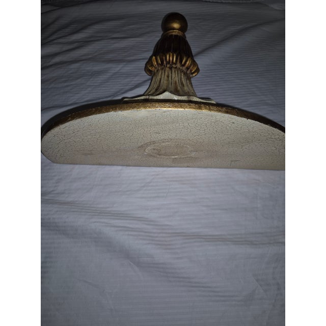 This vintage Italian Neoclassical-style demilune wall sconce shelf features a scalloped corbel design with an antiqued...