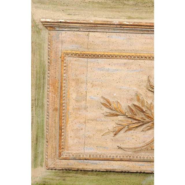 A French carved-wood wall plaque from the 19th century. This antique wall decoration from France is rectangular in shape,...