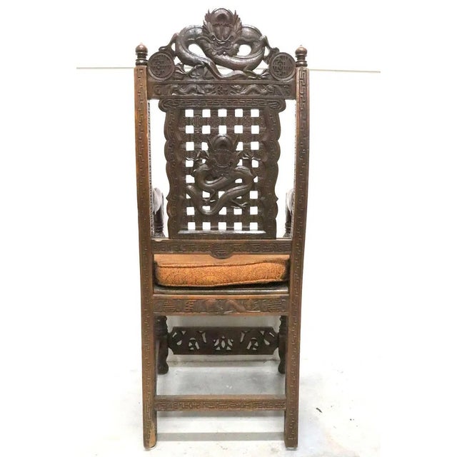 This product is a pair of antique heavily hand carved wooden armchairs from the late 19th century. They are intricately...