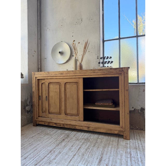 Antique workshop sideboard, a piece of furniture with sliding doors dating from the 1950s. Made of solid pine, it has a...