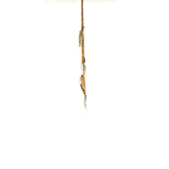 An Art Nouveau 15k yellow gold multi-strand festoon necklace. Features 5 natural white pearls and one diamond. Measures 15".