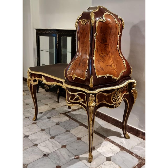 Make a commanding statement with this grand Louis XV-style writing desk, an exceptional piece distinguished by its...