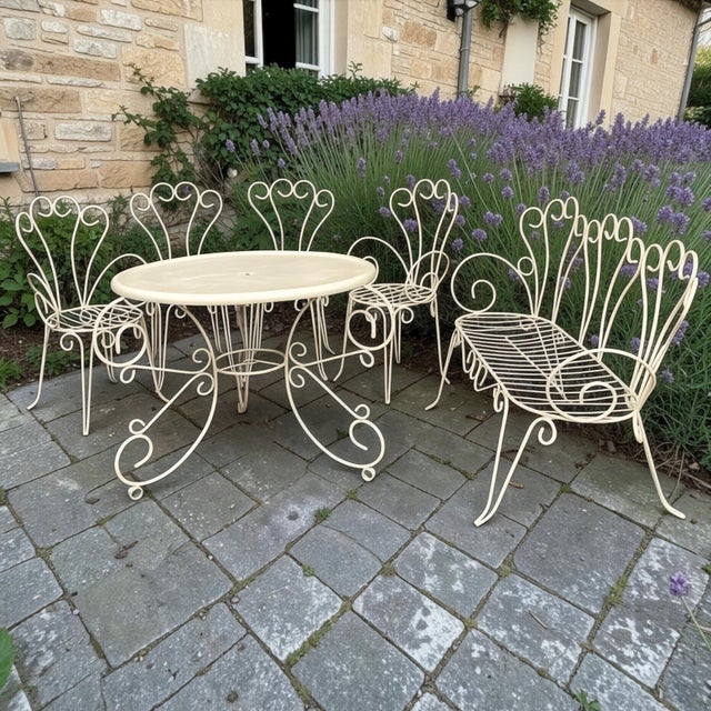 Mid-Century French Wrought Iron 6-Piece Garden Salon Set is a charming way to furnish your outdoor space! The cafe table...