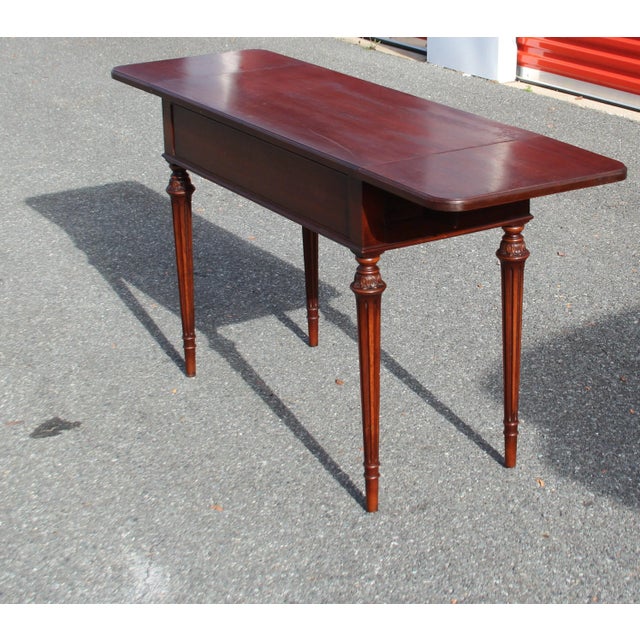 This Vintage Georgian Mahogany Drop-Leaf Writing Table is a timeless piece of furniture that embodies the classic elegance...
